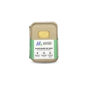 A cardboard box from Icelantic Skis holds the mountainFLOW Eco Wax Kit, featuring a green label that highlights its biodegradable, petroleum-free formula. Ideal for all temperatures, this high-performing ski wax is both eco-friendly and effective. A window in the packaging reveals the yellow biodegradable snowboard wax inside.