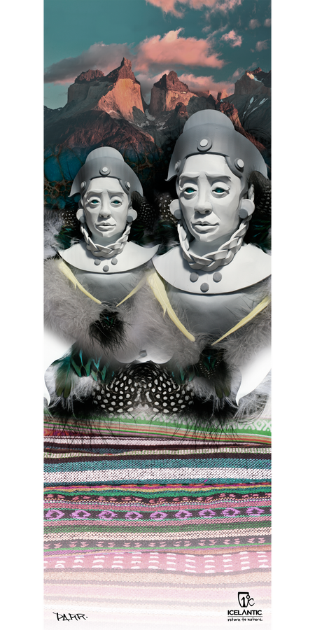 Two sculpted busts in traditional attire are set against colorful woven fabric and feathers, with dramatic mountain peaks and a pink-clouded sky beyond. The 15/16 Oracle Fine Art Print by Icelantic beautifully captures this captivating scene, bringing cultural heritage and vibrant landscapes to life as a stunning piece of wall art.