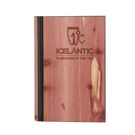 Introducing the Icelantic Notebook: a handcrafted journal featuring a real wooden cover with a distinctive black spine. The front displays the "ICELANTIC HANDMADE IN THE USA" inscription and logo, while natural wood grain patterns and unique knots highlight its authentic craftsmanship and singular character.