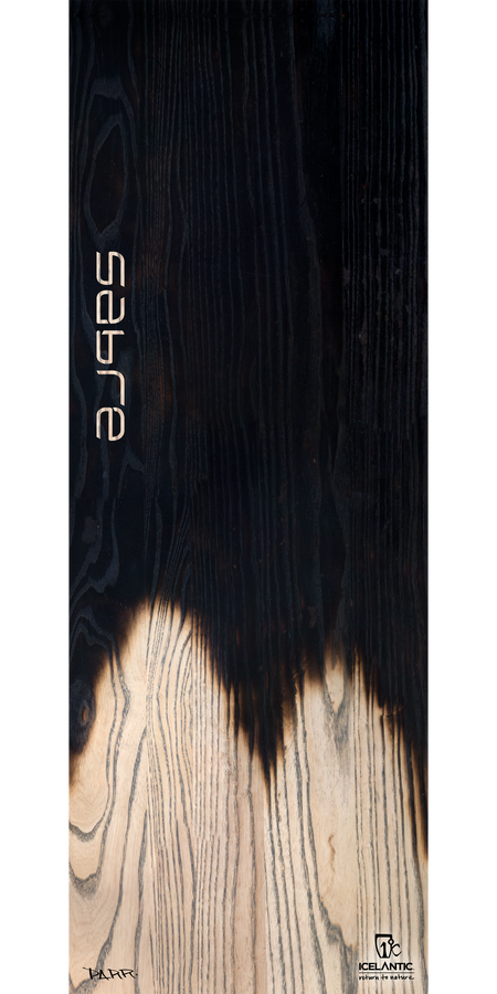 Close-up of the 18/19 Sabre ski by Icelantic, showcasing striking dark and light wood grain patterns with "sabre" displayed vertically. The lower right corner features the Icelantic logo, making this image ideal for fine art prints or as a dramatic giclee print on wrapped canvas.