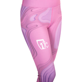 A person is wearing Icelantic 22/23 Mystic Legging in pink and purple abstract pattern, featuring a high-waist waistband and a white Icelantic logo on the left thigh. Only the lower torso and legs are visible, highlighting the sleek fit of the WIKMAX Fabric.