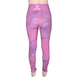 A person stands barefoot with their back to the camera, wearing high-waisted, pink and purple patterned 22/23 Mystic Leggings by Icelantic. The high-rise waistband prominently displays the Icelantic logo and text, highlighting a blend of style and comfort.