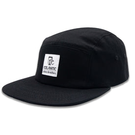 The RTN 5-Panel - Black by Icelantic Skis is a five-panel cap made from durable cotton twill. It features a flat brim and a white rectangular patch on the front that reads "Icelantic Return to Nature." The hat is photographed against a white background.
