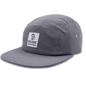 Introducing the RTN 5-Panel - Grey by Icelantic Skis: a classic five-panel cap made from premium cotton twill in gray, featuring distinctive white stitching and metal side eyelets for enhanced breathability. The front displays a rectangular white patch with the Icelantic Skis logo and "Return to Nature" text, making this essential hat perfect for any outdoor adventure.