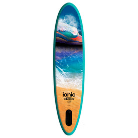 A vibrant teal paddleboard featuring a lively ocean wave design with sandy beach and blue water accents. The Ionic X Parr Paddleboard - All Water Teal by Icelantic Skis displays the words "ionic BOARDS" and "11.8 FT" near the bottom, complemented by a black handle on the tan section—ideal for all water adventures.