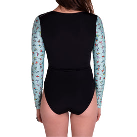 A person wearing the Icelantic Skier LS One Piece, a chlorine-resistant, long sleeve swimsuit with light blue sleeves and colorful cartoon graphics, is shown from the back against a white background. This stylish swimsuit also provides UV protection for all-day outdoor comfort.
