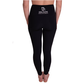 A person is shown from the back, barefoot, standing against a white background and wearing Icelantic Skier Pocket Legging - Black/Pink. The high-waisted leggings feature the white ICELANTIC Return to Nature logo printed on the waistband.