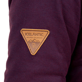 Close-up of a purple Sherpa Lined Jacket by Icelantic featuring a brown, triangular patch with mountain graphics and the words ICELANTIC GOLDEN, COLORADO—ideal for those who value sustainable apparel that combines warmth and style.