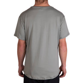 A person wearing the Icelantic SoftTECH T - Greenish, a comfortable t-shirt with advanced wicking technology, is shown from the back against a white background.