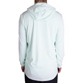 A person is wearing the Icelantic UV Sun Hoodie in Clearly Aqua, seen from the back against a white background. The hood is up but not covering the head, and their hands rest relaxed at their sides. This quick-dry shirt provides UPF 50 protection for comfortable all-day wear.