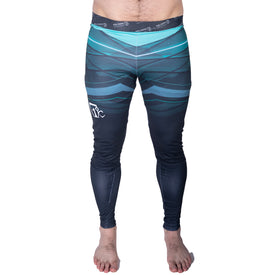 A person is barefoot against a white background, wearing the Icelantic 22/23 Mens WiKmax Baselayer Full Bottom—sleek athletic leggings featuring a blue and green gradient design.